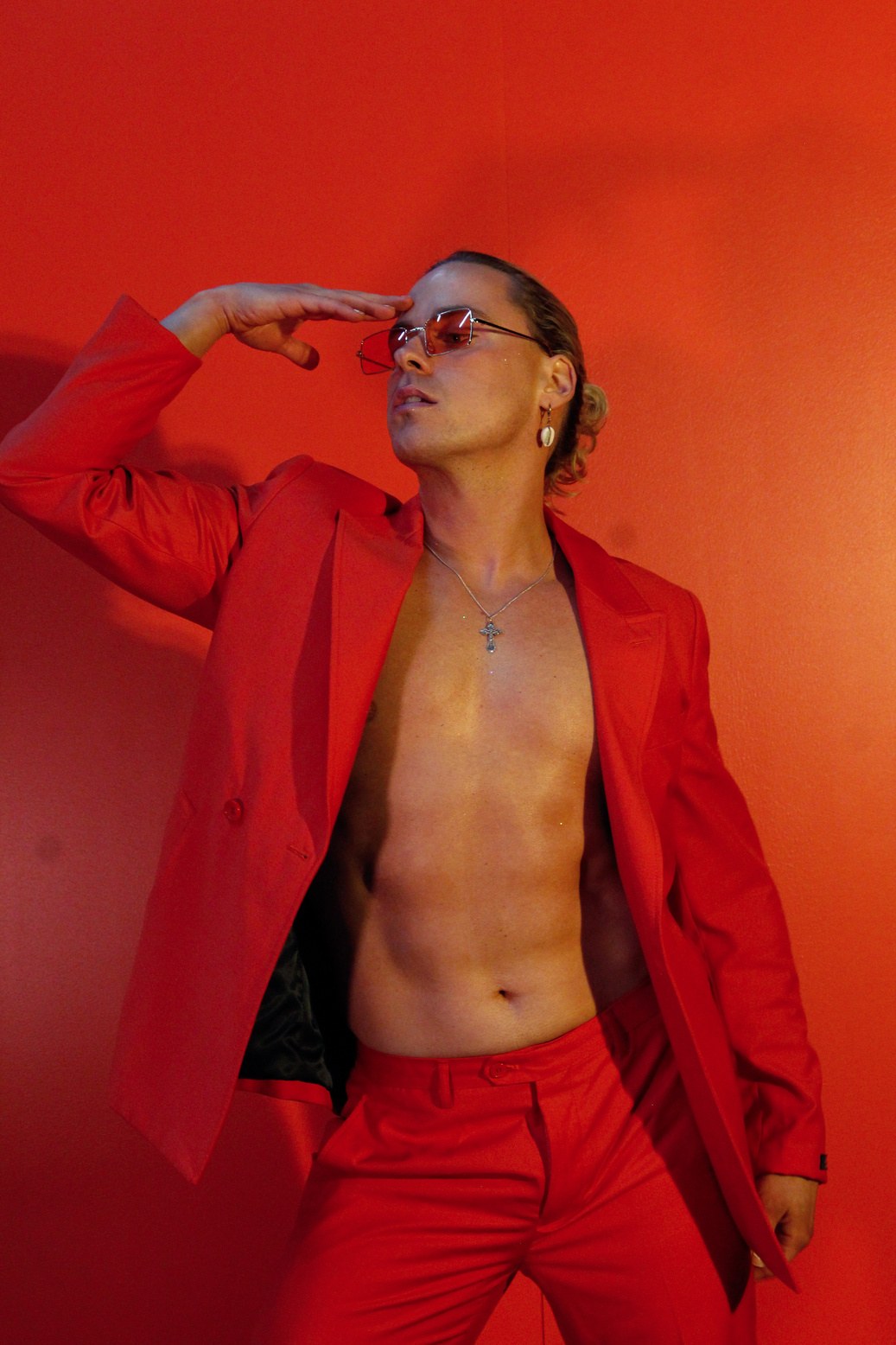 Toni wearing an orange suit and sunglasses